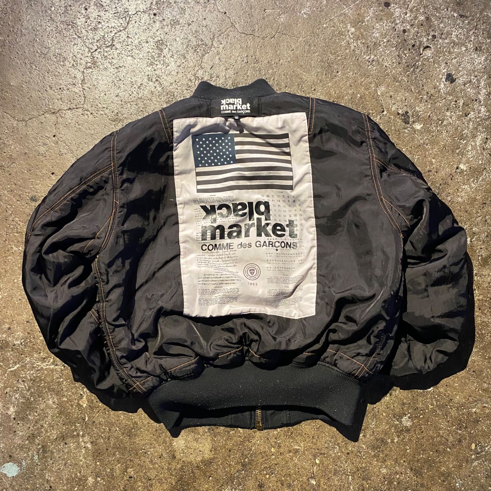 COMME des GARCONS black market × ALPHA ロゴパッチ MA-1 ジャケット