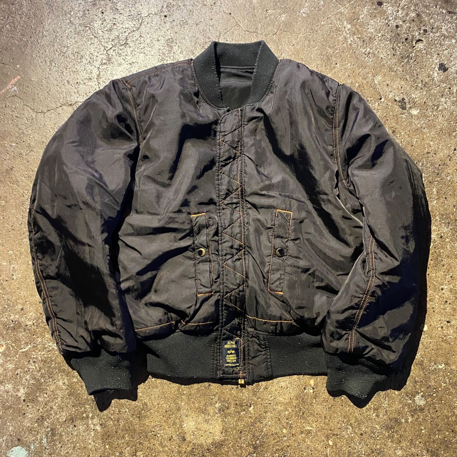 COMME des GARCONS black market × ALPHA ロゴパッチ MA-1 ジャケット