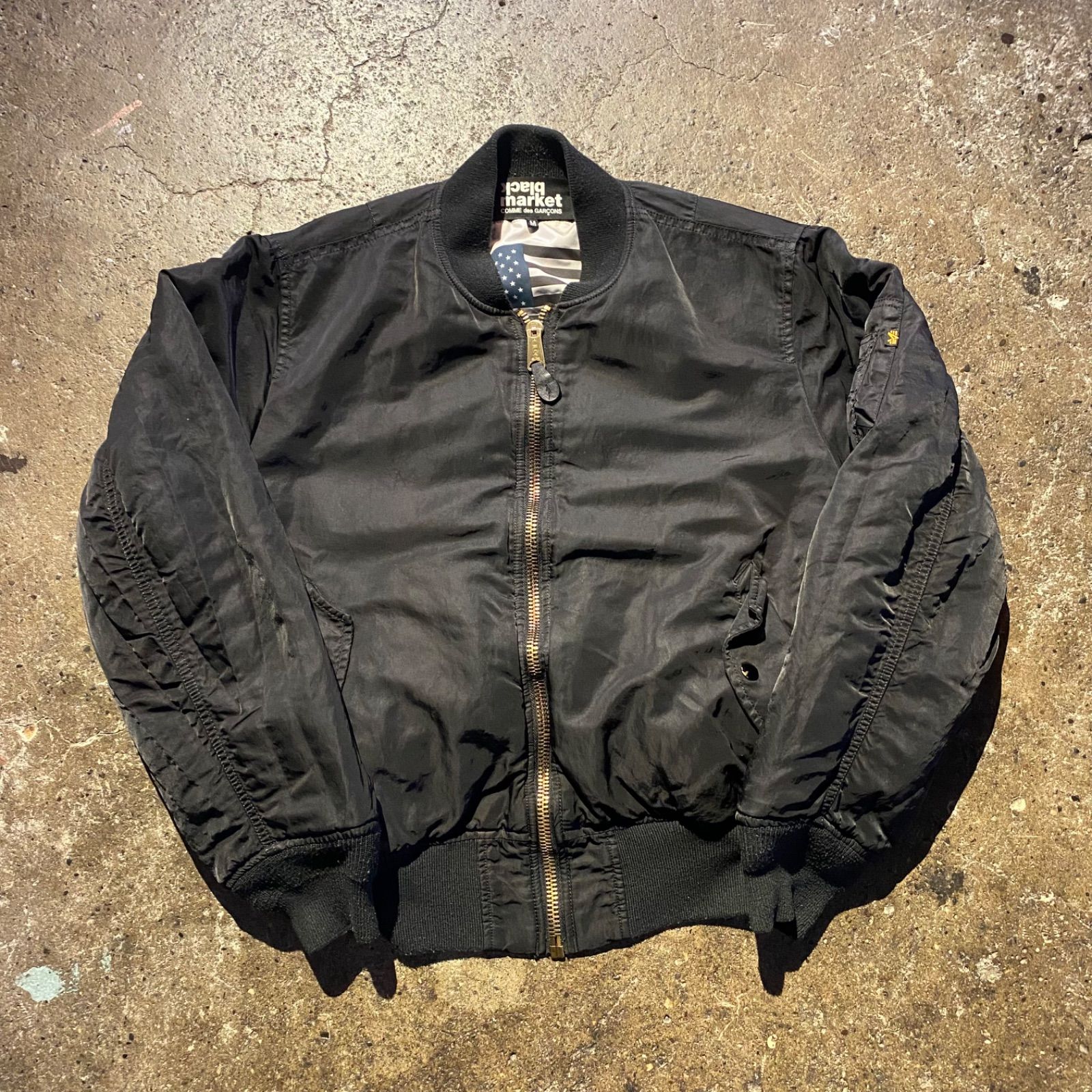 COMME des GARCONS black market × ALPHA ロゴパッチ MA-1 ジャケット