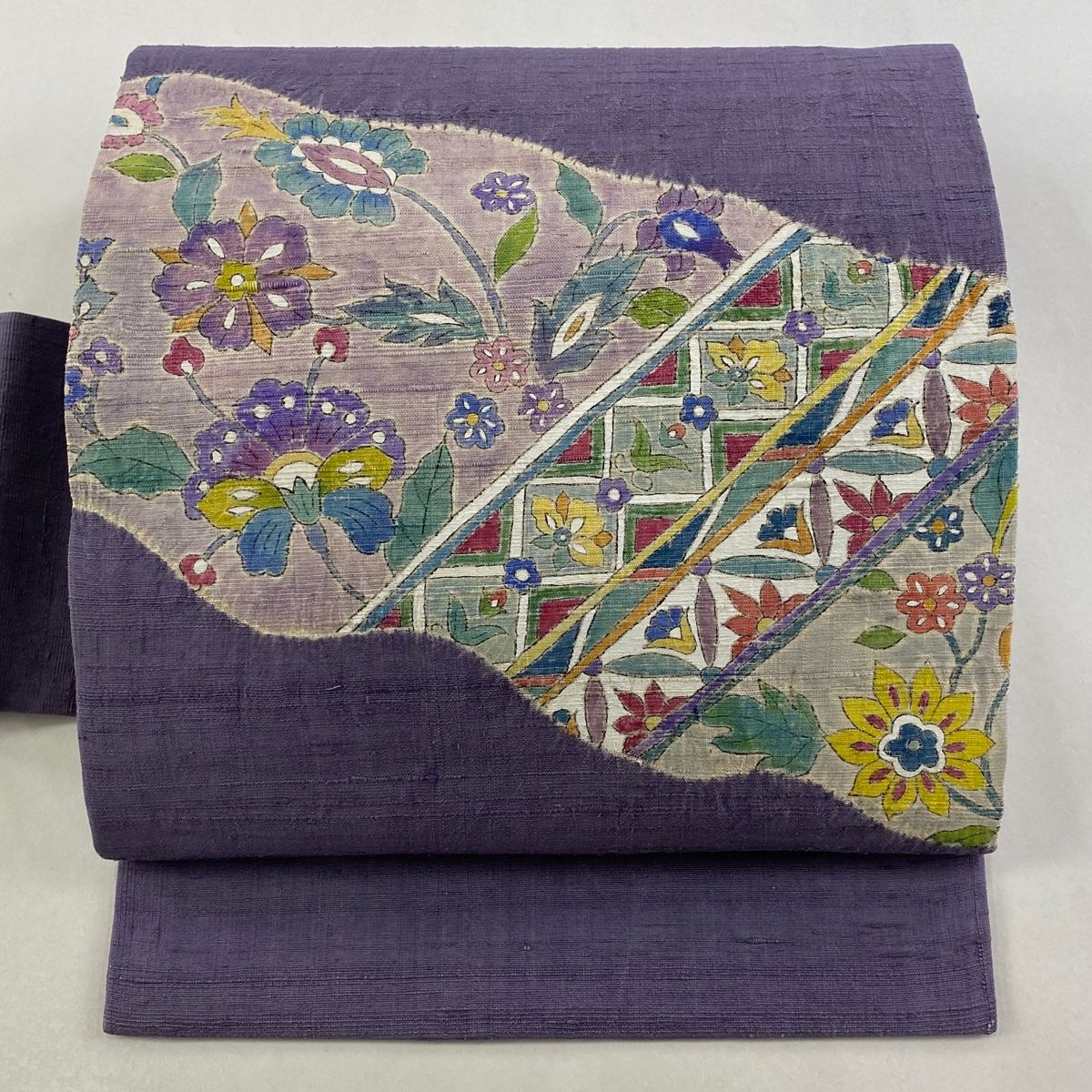 名古屋帯 秀品 紬地 草花 道長取り 絞り 紫 正絹