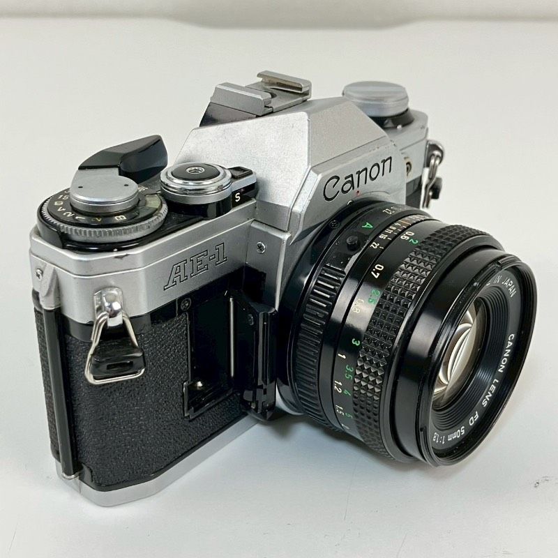  Canon キヤノン AE 1 シルバー LENS FD 50 mm F 4 1980オリンピックキャップ MF ー眼レフ フィルムカメラ 一眼レフカメラ(フィルム) フィルムカメラ