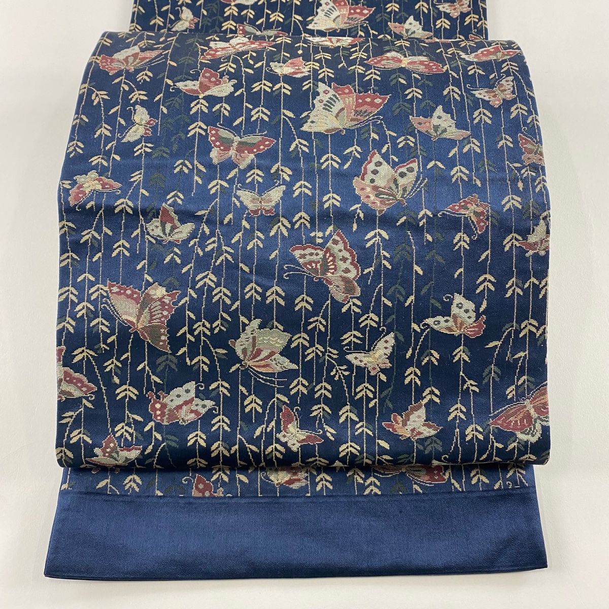 袋名古屋帯 証紙 とみや織物 蝶 葉柄 紺色 正絹