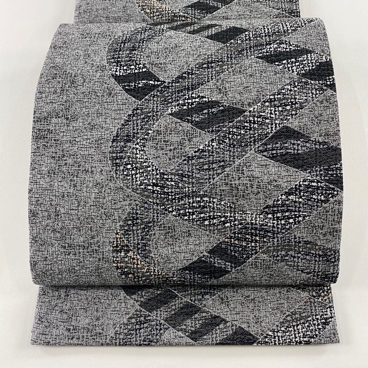 袋帯 ぜんまい紬 幾何学 纐纈更紗 黒灰 六通 正絹