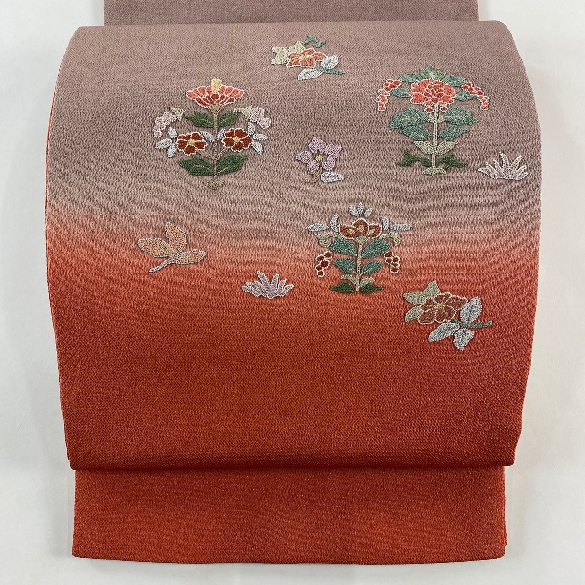 袋帯 秀品 草花 相良刺繍 縮緬 朱色 お太鼓柄 正絹