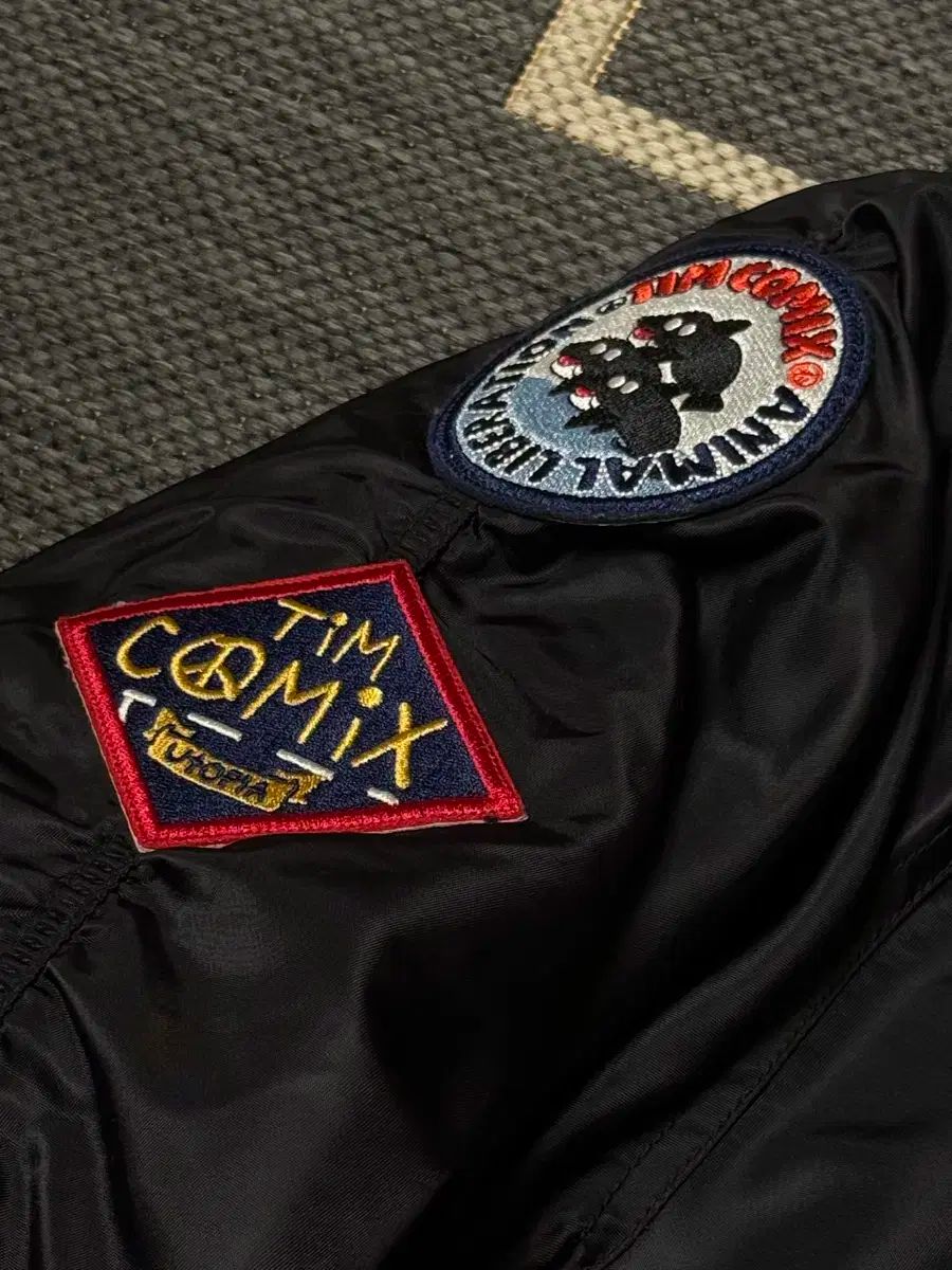 チームコミックス パッチド MA-1 フーディー デッキ アウター ブラック S