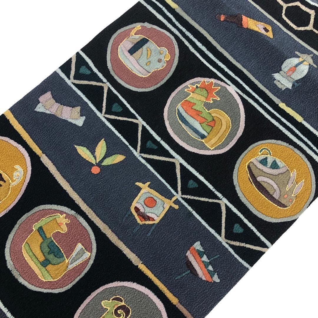 名古屋帯 抽象干支柄 羽子板 兜 こっぽり 青褐色 縮緬 O-5700