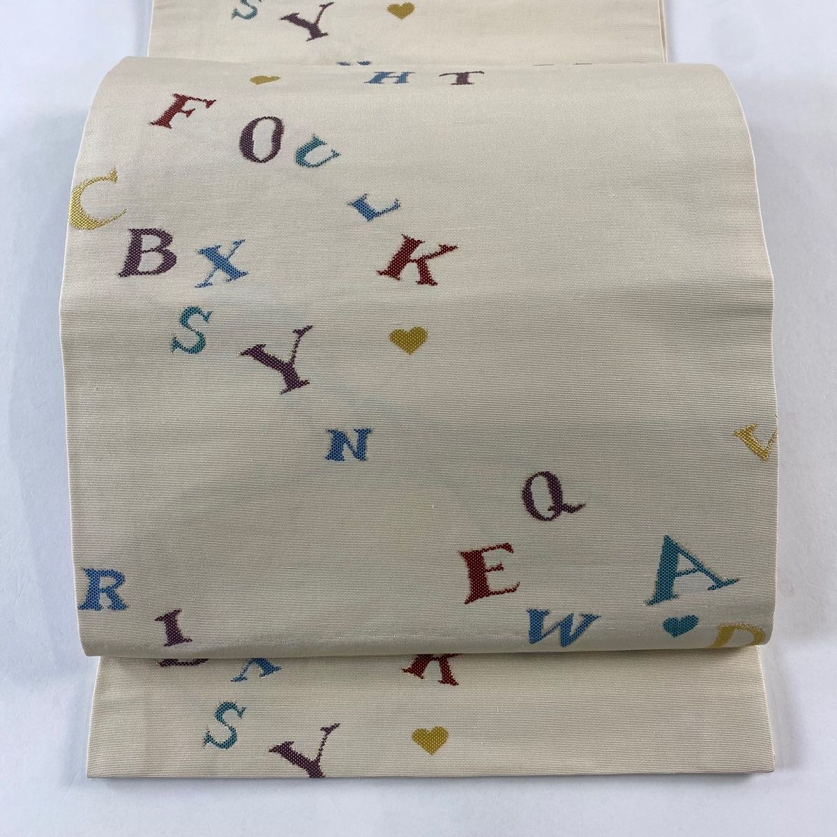 開き名古屋帯 アルファベット クリーム 正絹