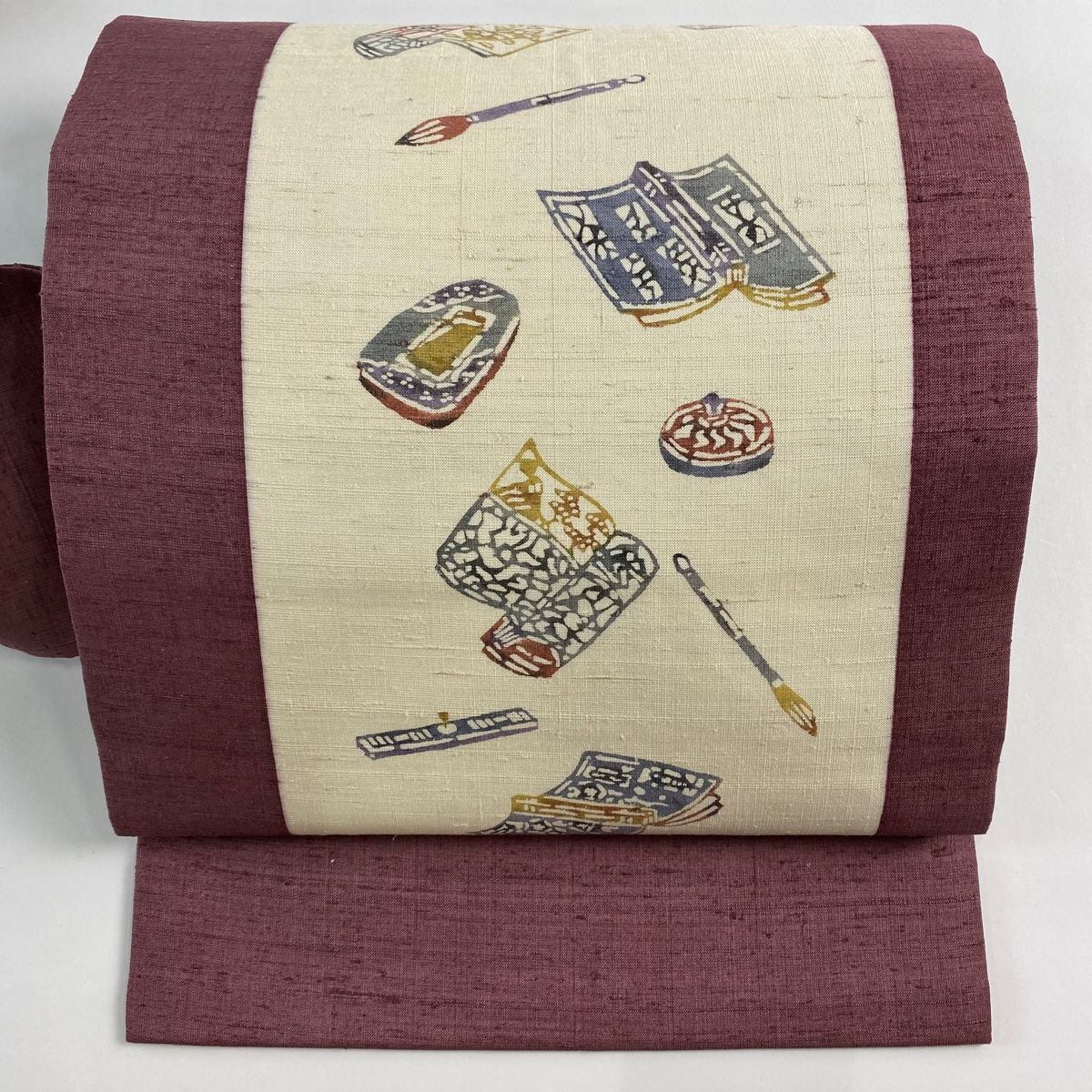 名古屋帯 秀品 紬地 冊子 筆 小豆色 正絹