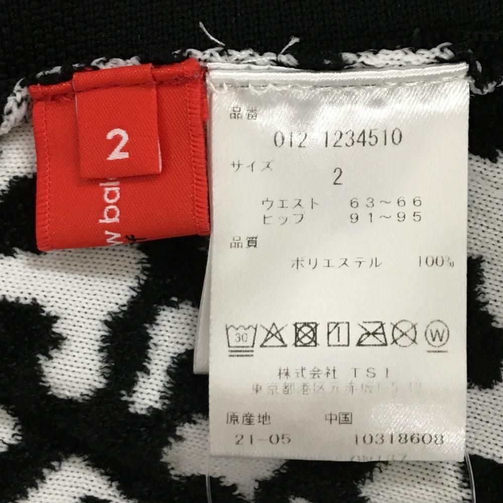 美品】ニューバランスゴルフ ニットスカート 黒×白 総柄 凹凸地 サイド