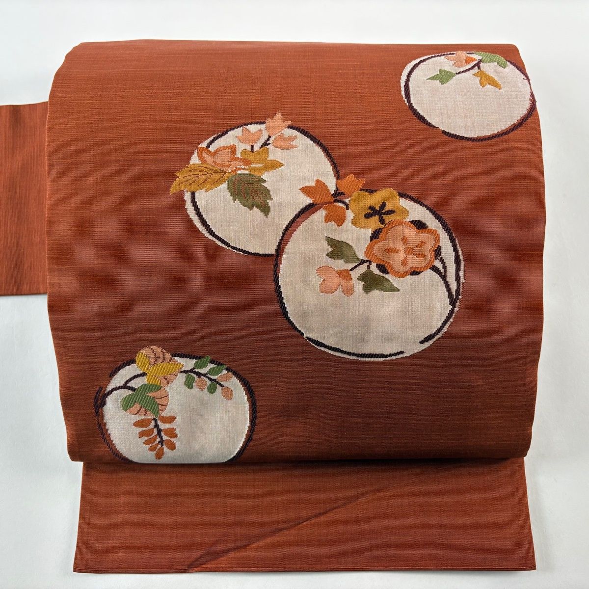 名古屋帯 秀品 紬地 関西仕立て 丸文 枝花 刺繍 赤茶 正絹