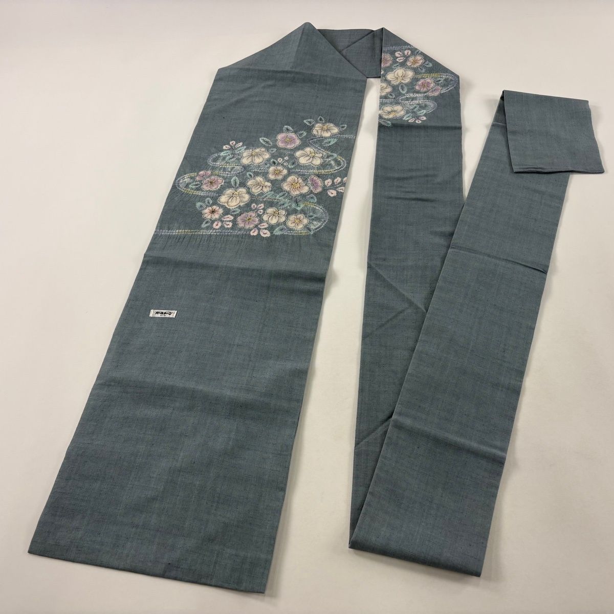 流水に草花と燕柄　染めと絞りの美しい紬名古屋帯 帯のアトリエ花邑-hanamura- 銀座店 「流水に草花文様 型染め 名古屋帯」