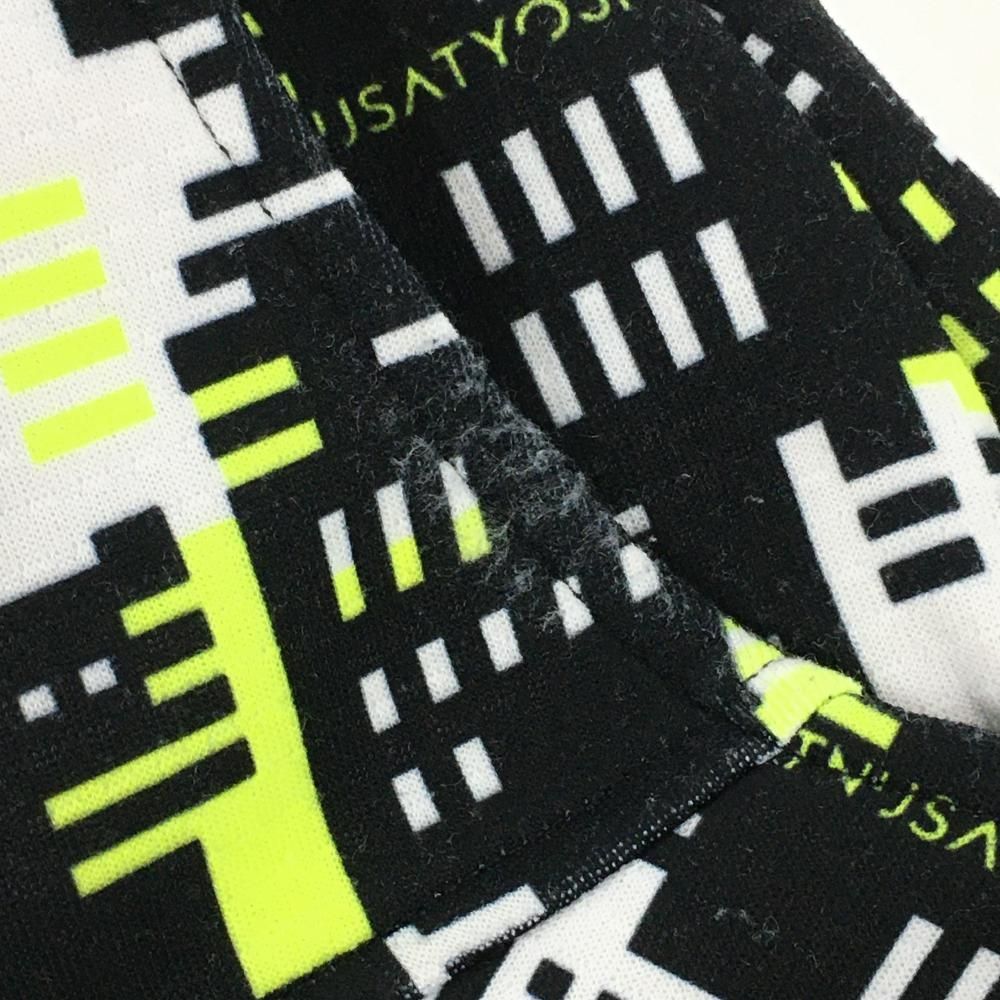 美品】ニューバランスゴルフ スカート 白×黒×蛍光イエロー 総柄 ロゴ