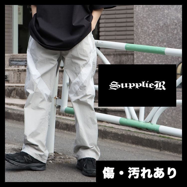 SUPPLIER サプライヤー PANELED TRACK PANTS リフレクタープリント トラックパンツ