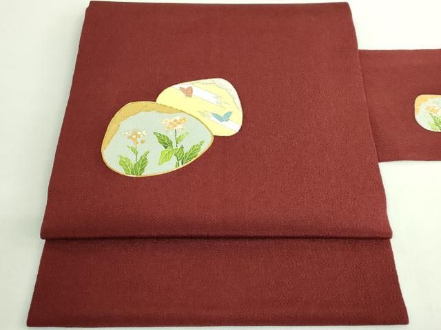 ● 上 銀座 志ま亀 九寸名古屋帯 駒刺繍 貝合わせ花文 赤銅色地 金彩 鬼しぼ縮緬 たとう紙付き kh 6