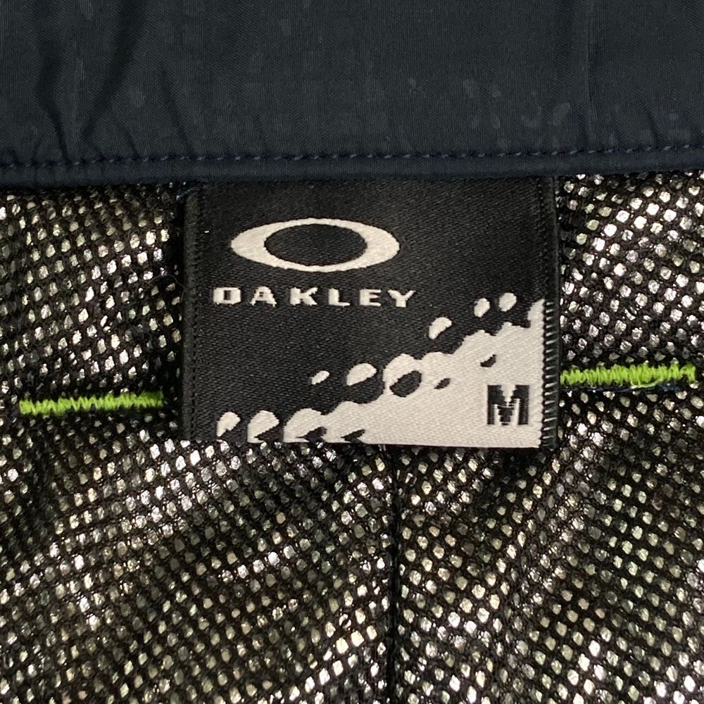 サイズ：M OAKLEY オークリー 422134JP 中綿パンツ 総柄 ネイビー系 [240101586104] ゴルフウェア メンズ ストスト サイズ：M OAKLEY オークリー 422134JP 中綿パンツ 総柄 ネイビー系