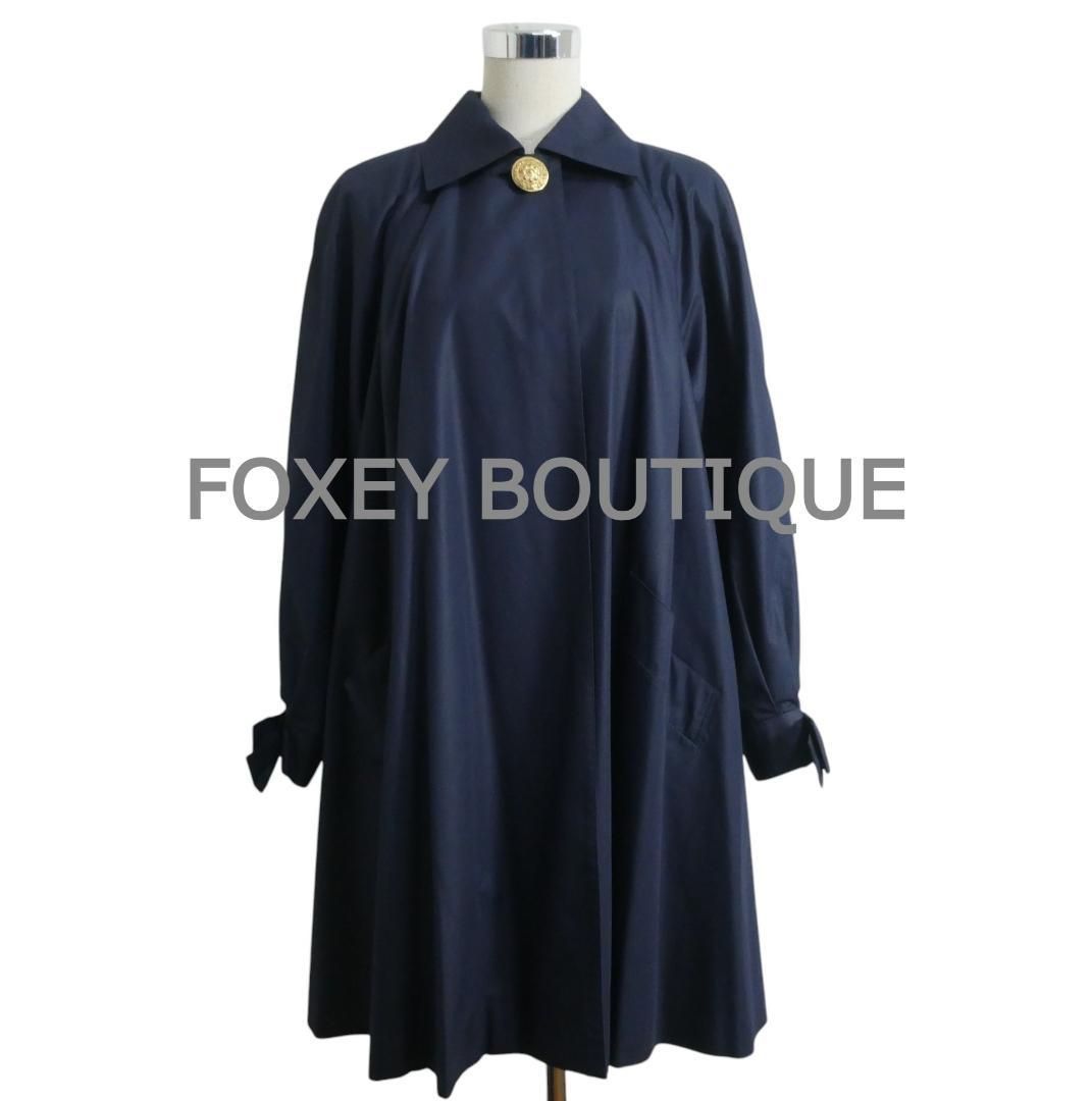 FOXEY フォクシーブティック サイズ40 ポリエステル コットン 金ボタン 袖リボン ラグランスリーブ 1 B スプリングコート ステンカラーコート ロングコート 紺 ネイビー レディース