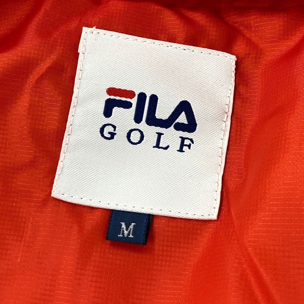 サイズ：M FILA GOLF フィラゴルフ  中綿ジャケット  オレンジ系 [240101602254] ゴルフウェア メンズ ストスト サイズ：M FILA GOLF フィラゴルフ 中綿ジャケット オレンジ系