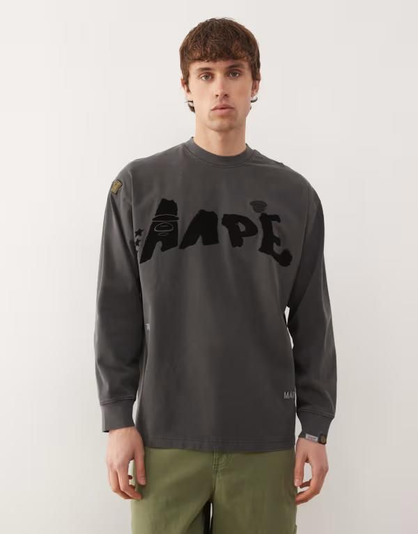 ベイシング エイプ メンズ トップス Tシャツ プリント Aape By A Bathing Ape oversized long sleeve Tshirt in washed black with graffiti print Black ブラック
