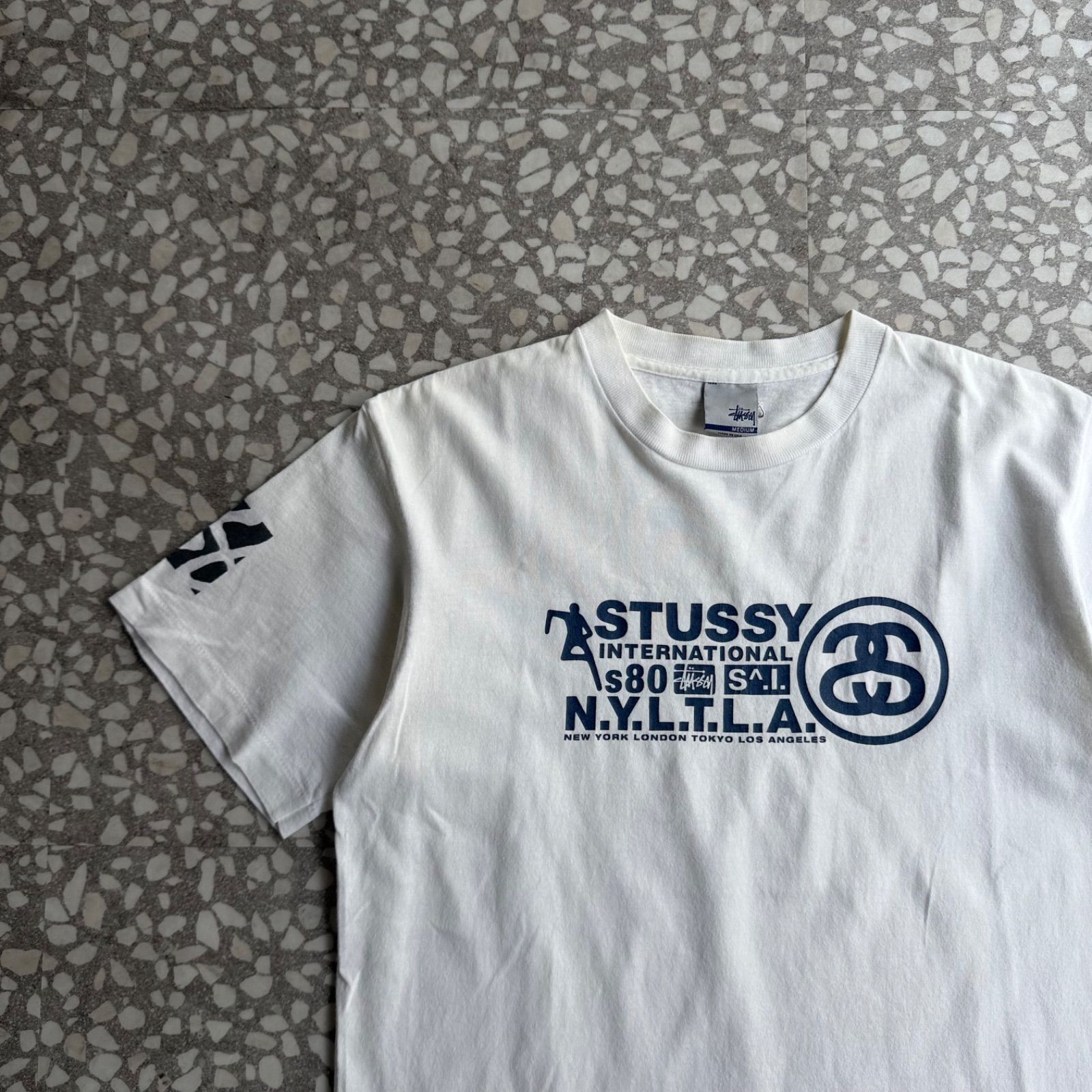 STUSSY / 00’s usa製 NYLTLA T-shirt オールドステューシー　シングルステッチ アメリカ製　ストリート　ユニセックス　半袖 ワールドツアー　ワールドトライブ　世界都市　白T sk8