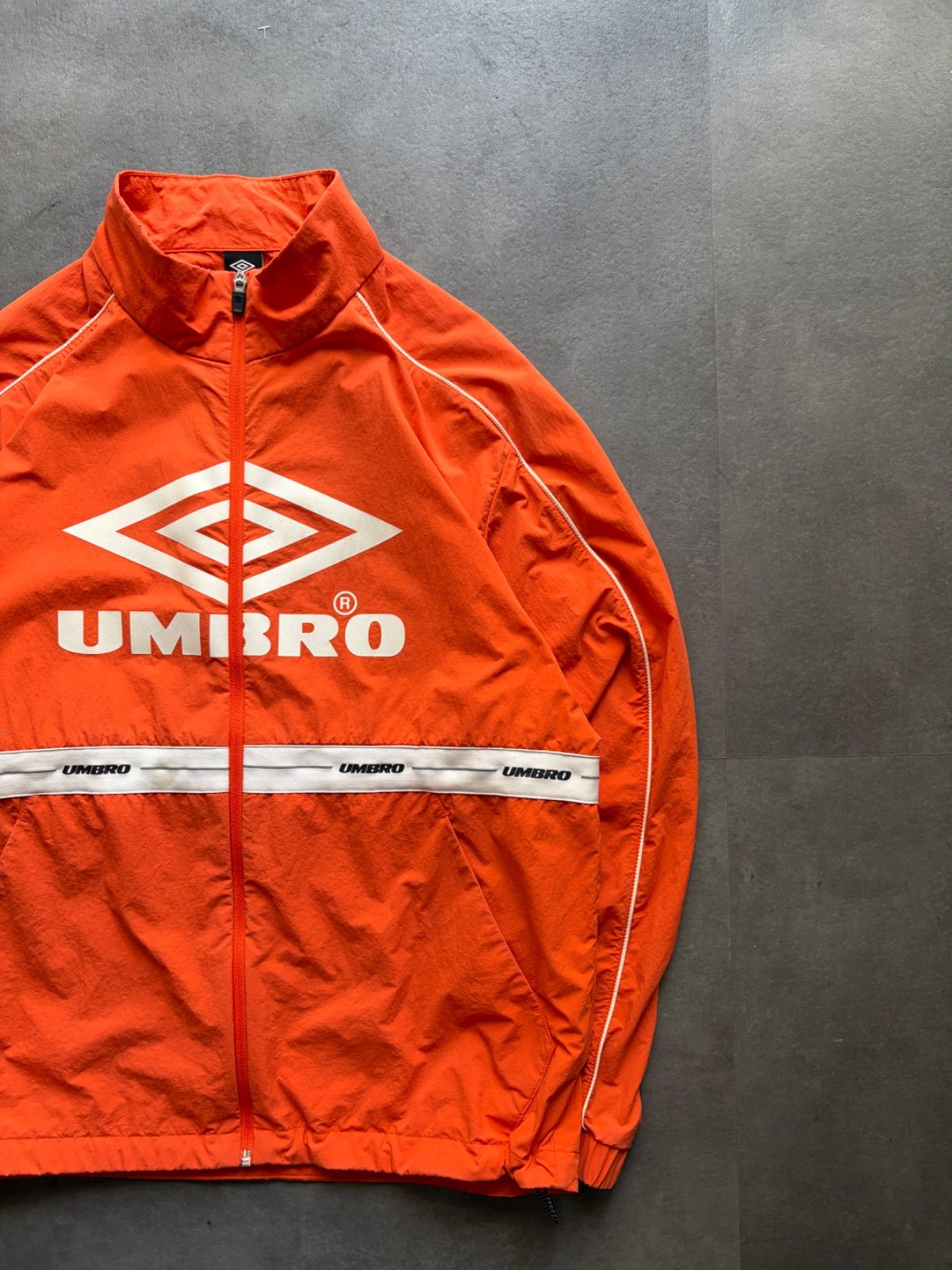 90s UMBROトラックジャケット刺繍ロゴ総柄オレンジマルチカラーY2Kテック UMBRO アンブロ ナイロンジャケット トラックジャケット オレンジ