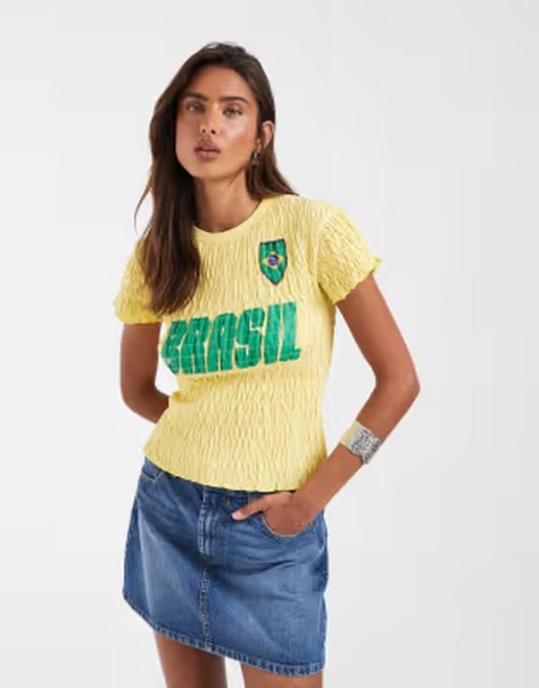 エイソス レディース トップス Tシャツ グラフィック ASOS DESIGN shirred baby tee with Brasil soccer graphic in yellow イエロー