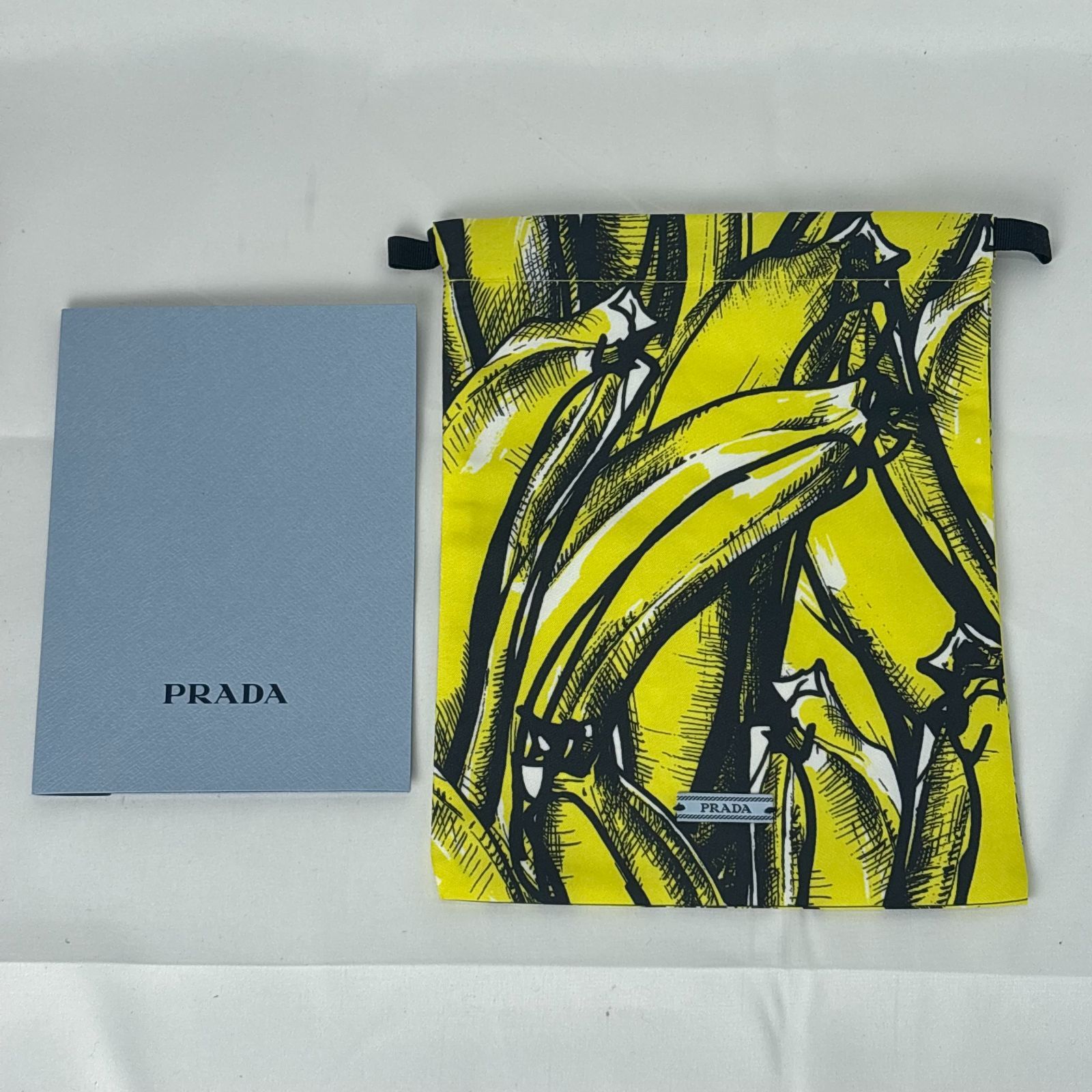 PRADA プラダ バナナ柄 巾着 ポーチ 黄色 黒 - メルカリ