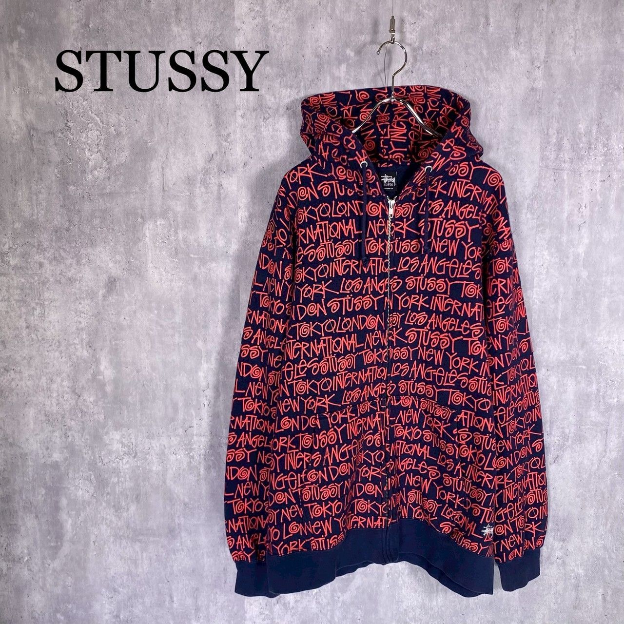 『STUSSY』ステューシー (XL) ロゴグラフィック総柄プリントパーカー フーディー