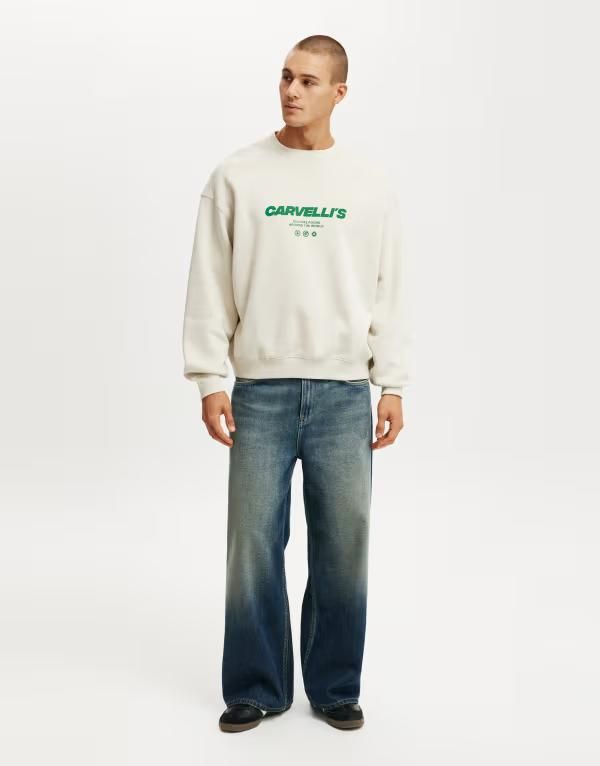 コットンオン メンズ アウター ニット・セーター クルーネック グラフィック Cotton boxy fit graphicrew neck sweater in bone carvellis BONE CARVELLI S