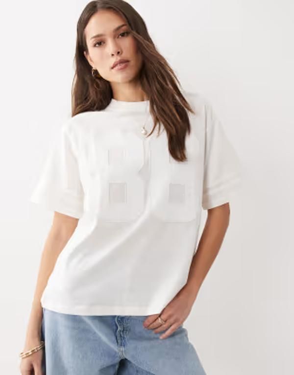 エイソス レディース トップス Tシャツ グラフィック ASOS DESIGN oversized football Tshirt with raised 86 varsity graphic in cream クリーム