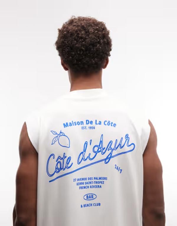 エイソス メンズ トップス ベスト グラフィック ASOS DESIGN oversized tank with Cote dAzur graphic in cream Coconut milk クリーム