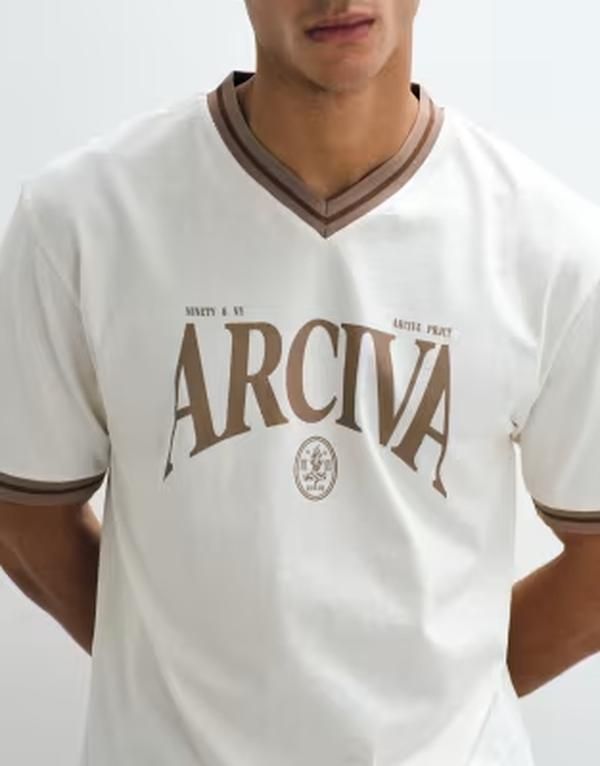 エイソス メンズ トップス Tシャツ グラフィック ASOS DESIGN relaxed ringer tshirt with arciva graphic in cream Coconut mil