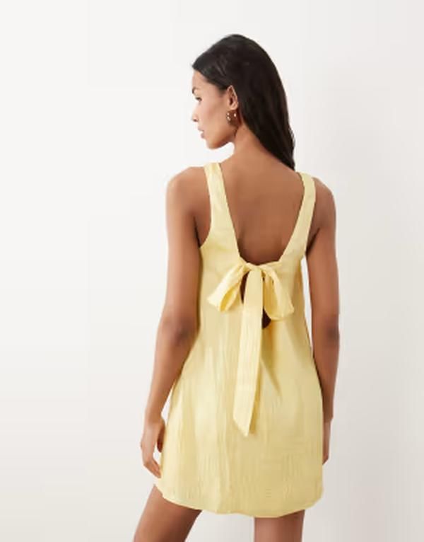エイソス レディース トップス ワンピース ミニ ASOS DESIGN shift mini dress with bow back detail in yellow イエロー
