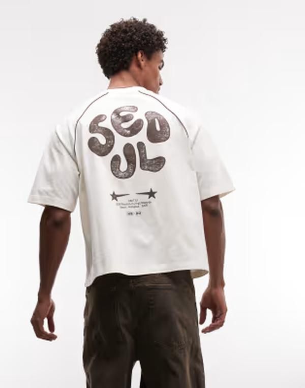 エイソス メンズ トップス Tシャツ グラフィック ASOS DESIGN boxy oversized tshirt with Seoul bubble graphic in cream Cocon