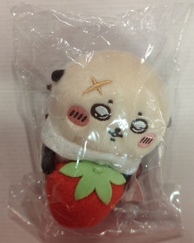 Grey Parker Service: An otter holding a strawberry holding a hook plush toy that watches over from the desktop