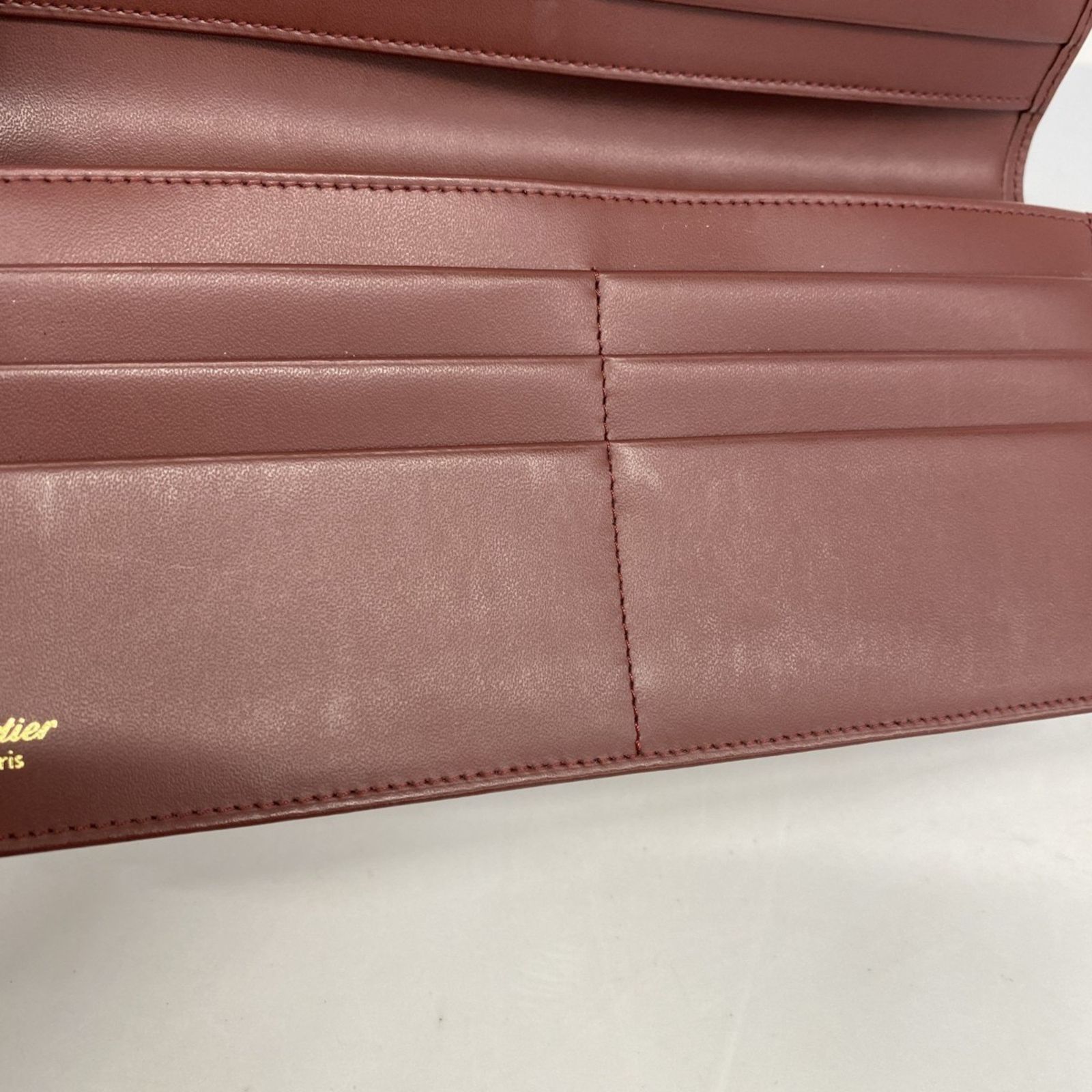 カルティエ 鑑定済極美品 バーガンディ レザー 長財布 エンボスロゴ
