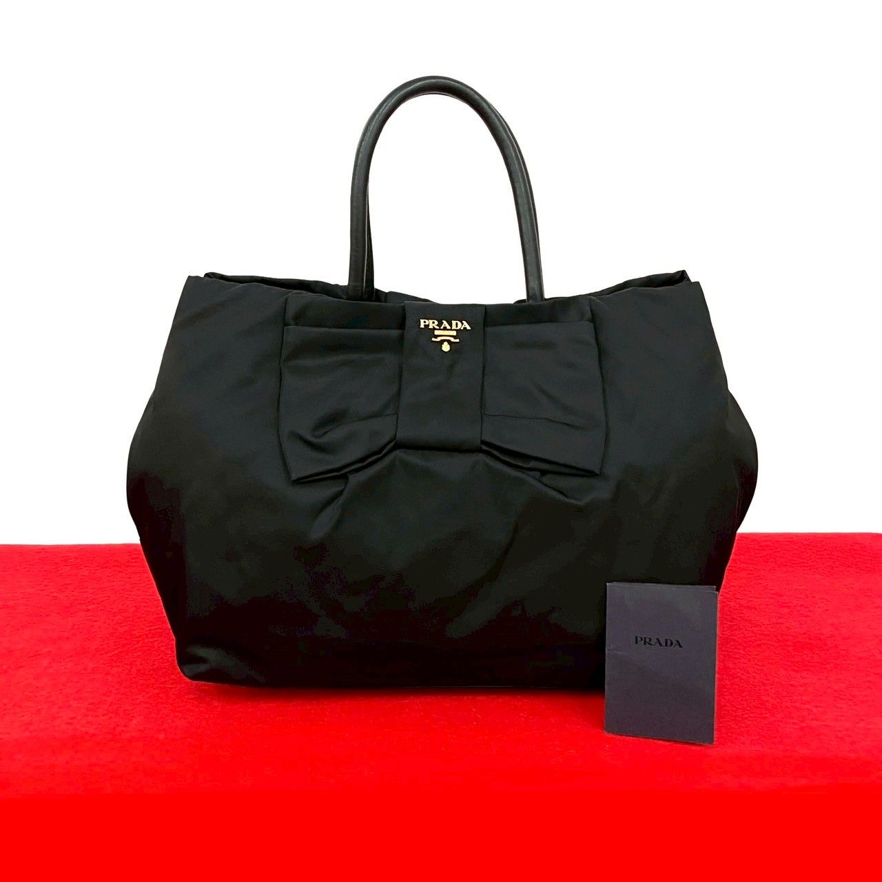 PRADA プラダ ロゴ 金具 リボン モチーフ テスート ナイロン レザー 本革 ハンドバッグ ミニ トートバッグ ブラック 63258