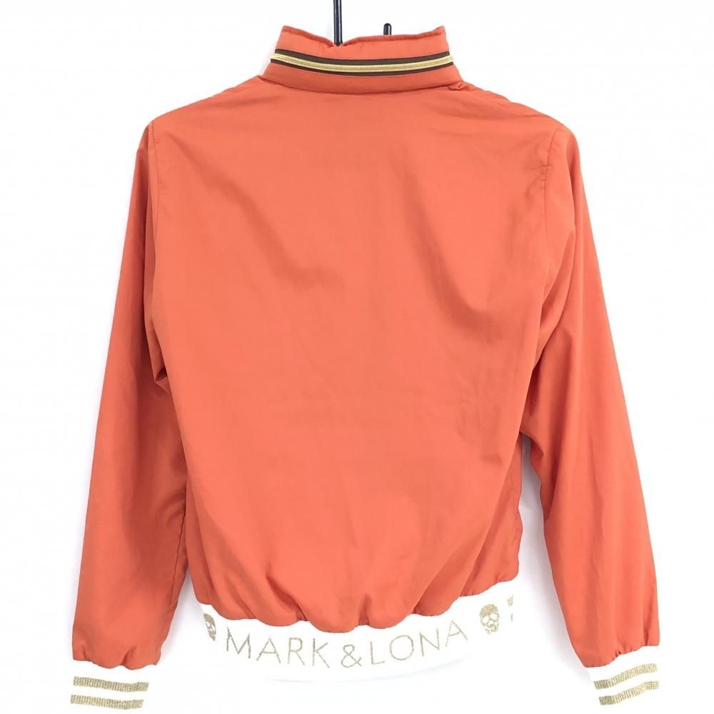 超 マークアンドロナ ジャケット オレンジ 裾ロゴ スカル メッシュ裏地 フード収納可 レディース ゴルフウェア MARK&LONA