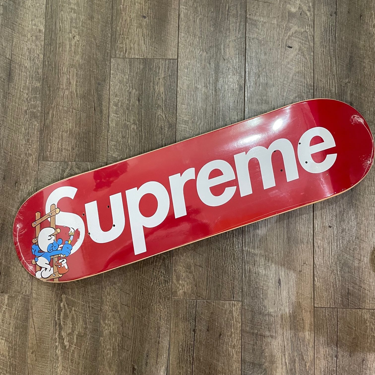 supreme smurfs skateboard red