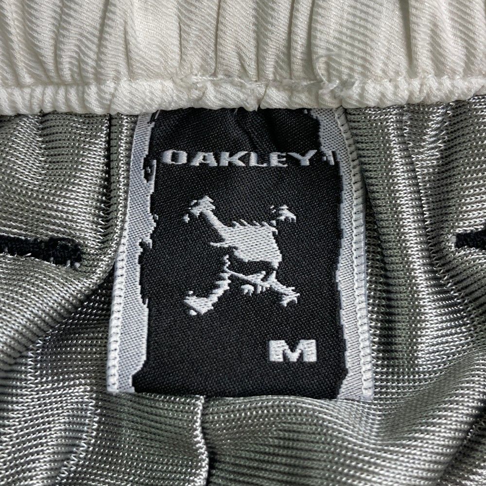 サイズ：XL OAKLEY オークリー 421896JP ロングパンツ スカル刺繍 グレー系 [240101489898] ゴルフウェア メンズ ストスト サイズ：XL OAKLEY オークリー 421896JP ロングパンツ スカル