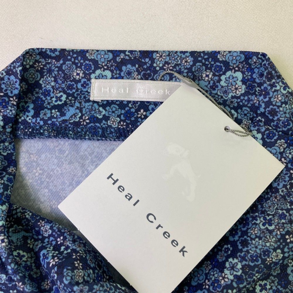 サイズ：42 HEAL CREEK ヒールクリーク  半袖ハイネックTシャツ 総柄 ネイビー系 [240101449142] ゴルフウェア レディース ストスト サイズ：42 HEAL CREEK ヒールクリーク 半袖ハイネックTシャツ