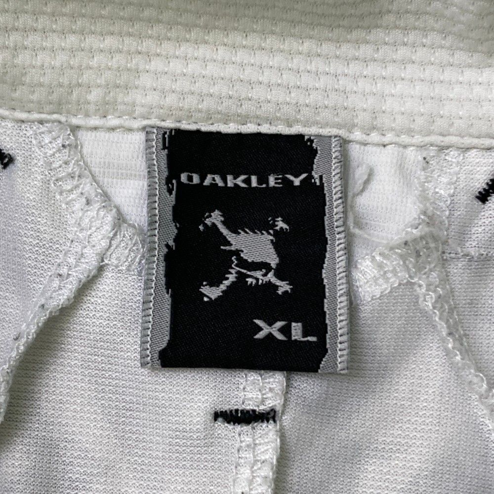 サイズ：XL OAKLEY オークリー 433622JP 半袖ポロシャツ ボタンダウン スカル 総柄 オレンジ系 [240101472867] ゴルフウェア メンズ ストスト OAKLEY オークリー 433622JP 半袖ポロシャツ ボタンダウン