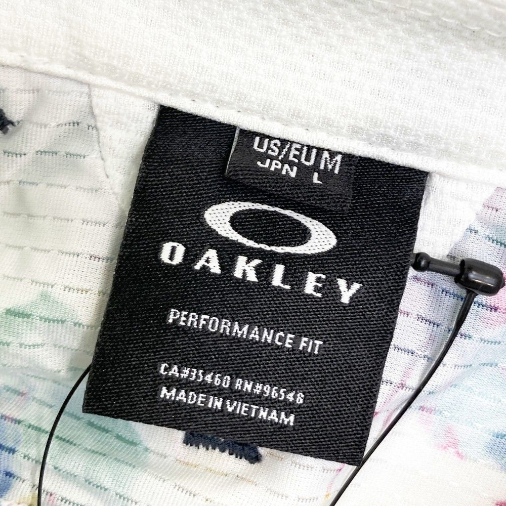 サイズ：L OAKLEY オークリー  半袖ポロシャツ 花柄 ホワイト系 [240101416957] ゴルフウェア メンズ ストスト サイズ：L OAKLEY オークリー 半袖ポロシャツ 花柄 ホワイト系