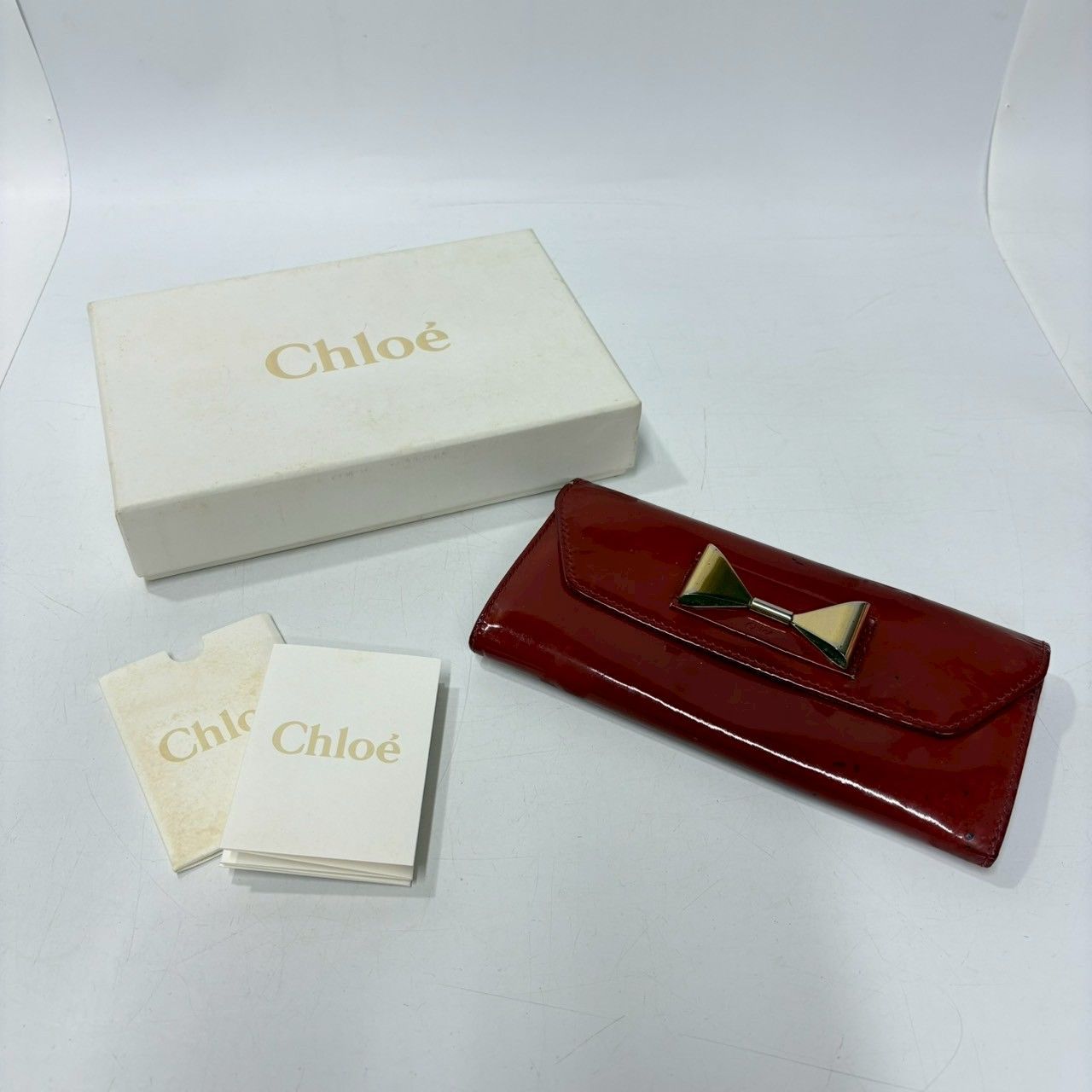 ☆M7 chloe クロエ エナメル 長財布 リボンモチーフ 留め具金具ボタン 
