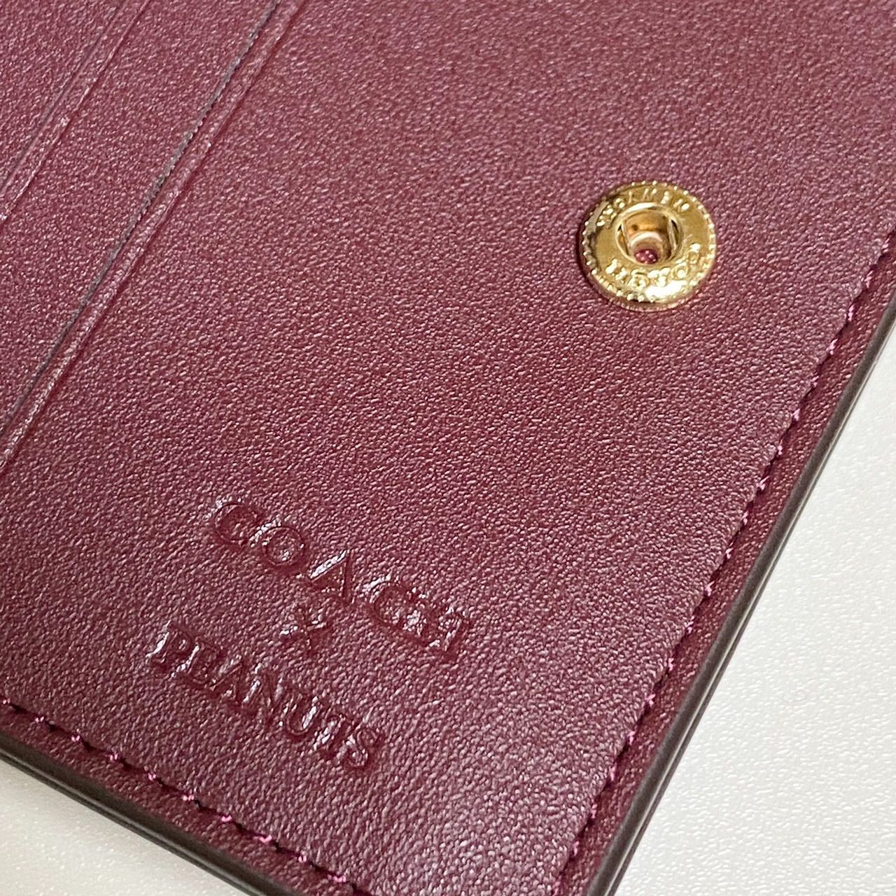 新品・国内在庫】COACH 二つ折り財布 スヌーピー ワインマルチ CF252