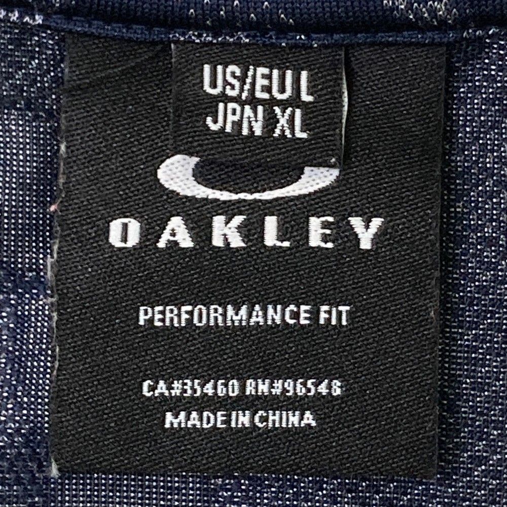 サイズ：XL OAKLEY オークリー  半袖ポロシャツ スカル 総柄 オレンジ系 [240101424118] ゴルフウェア メンズ ストスト オークリー ポロシャツ 上 メンズ OAKLEY ゴルフ 半袖 スカル