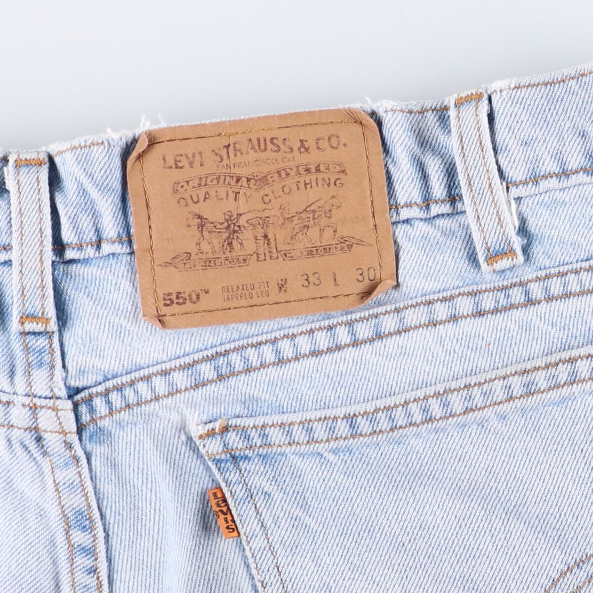 オレンジタブ テーパードデニムパンツ