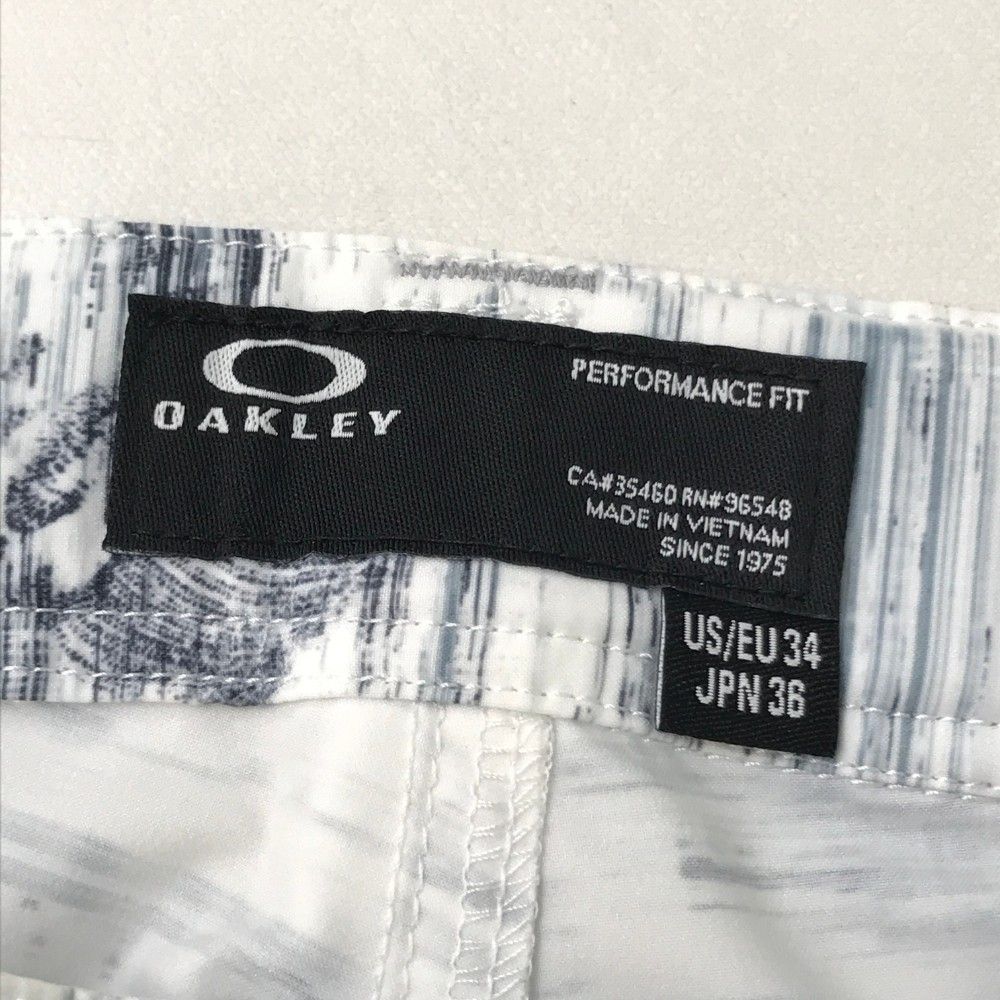 サイズ：36 OAKLEY オークリー FOA401634 ロングパンツ スカル刺繍 総柄 ネイビー系 [240101455307] ゴルフウェア メンズ ストスト サイズ：36 OAKLEY オークリー FOA401634 ロングパンツ スカル