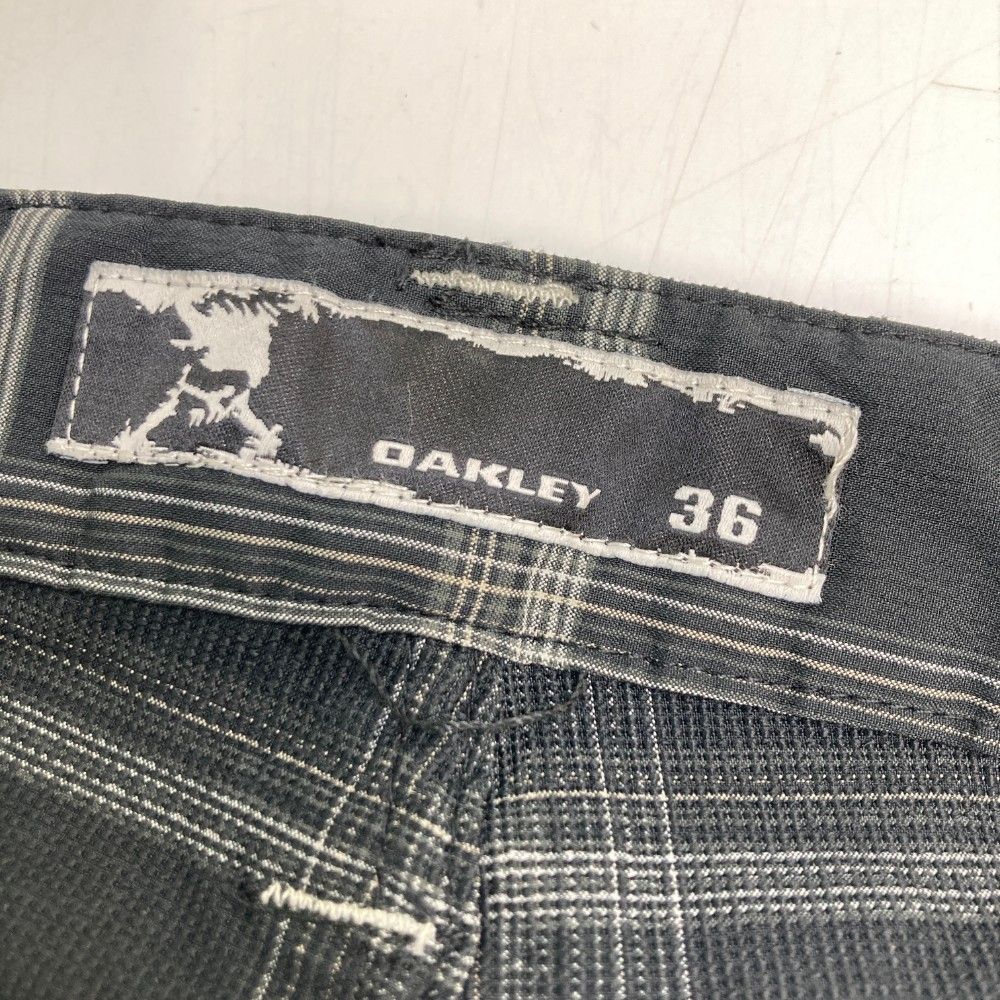 サイズ：36 OAKLEY オークリー 421828JP ロングパンツ スカル刺繍 チェック柄 グレー系 [240101421267] ゴルフウェア メンズ ストスト サイズ：36 OAKLEY オークリー 421828JP ロングパンツ スカル