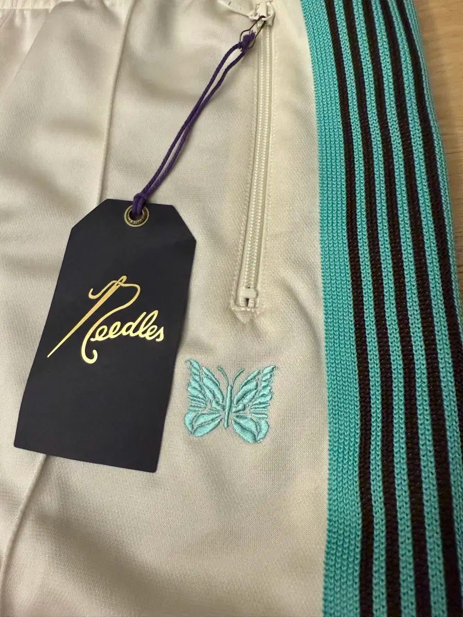 NEEDLES x STUDIOS H.D.トラックパンツ ポリ スムース エクリュ