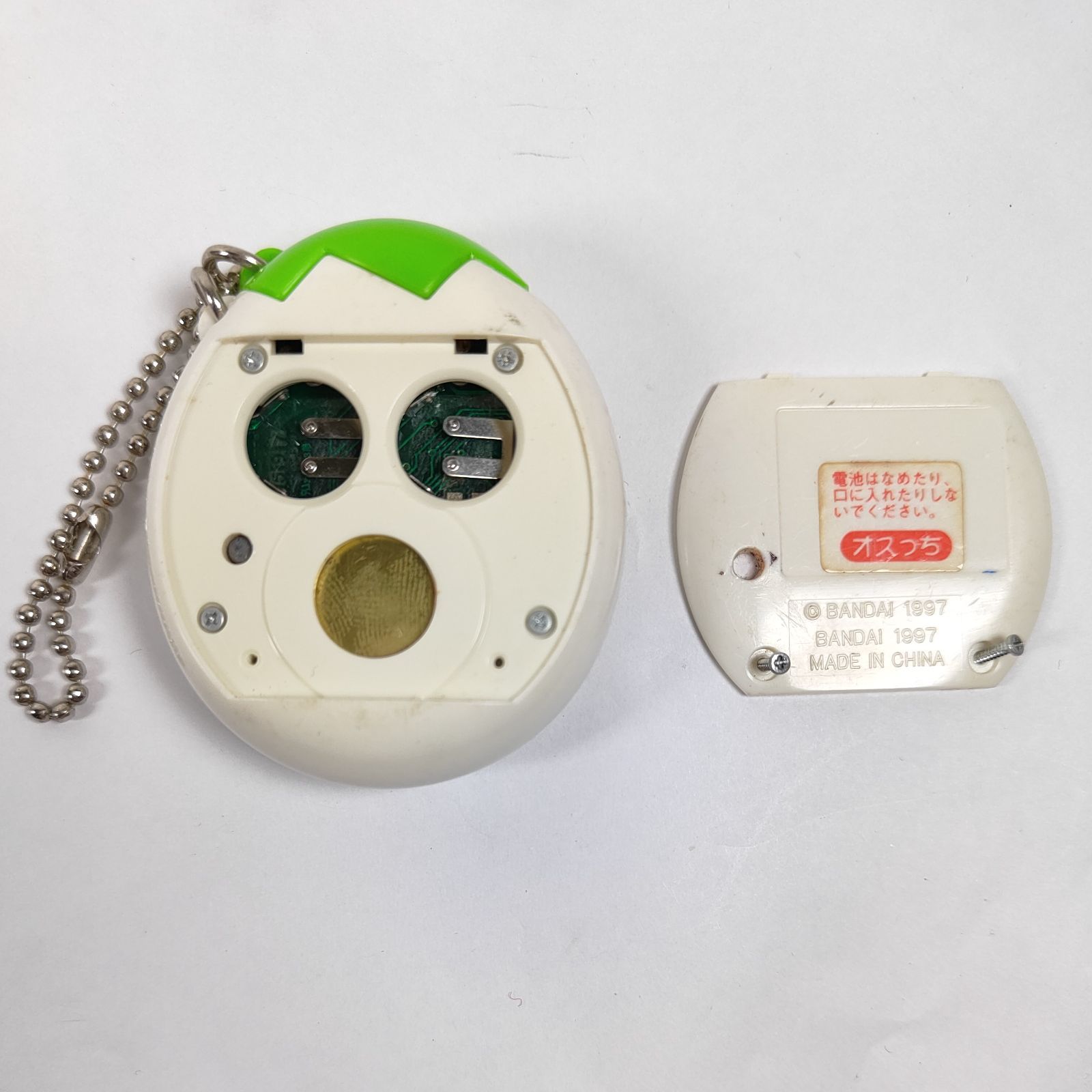 ​【電池抜き】初代たまごっち 本体（白）＆ 専用ケース（グリーン）2点セット ☆ オスっち たまごっち 白&グリーン バンダイ ☆ - メルカリ